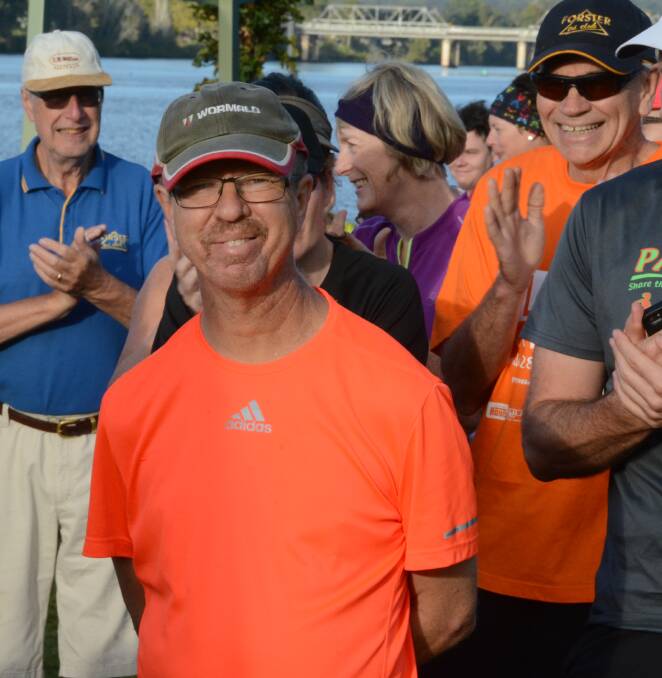 Russell Thornton is acknowledged by fellow runners before setting off on his 50th Taree parkrun. His brother, Phil, is pictured behind him. Russell will complete his 100th on Saturday. 