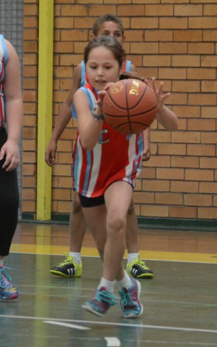 Lydia Ridgeway on the ball during the St Joseph Taipans-Wingham Red clash in the schools basketball competition at Taree.