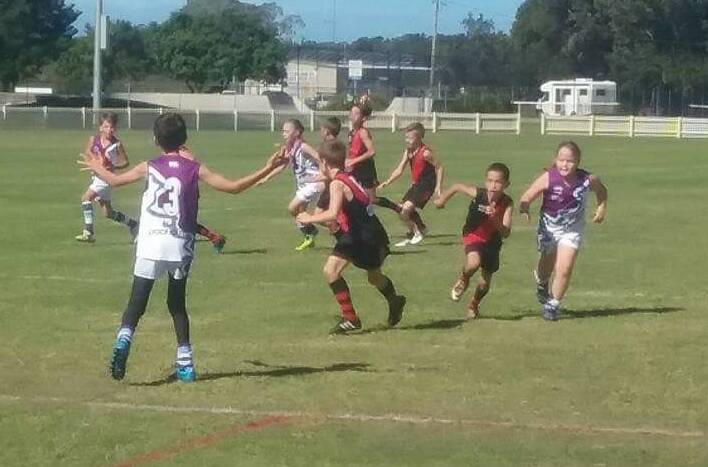 Manning Mustangs and Camden Haven players vie for possession during the North Coast under 11 AFL clash at Laurieton.