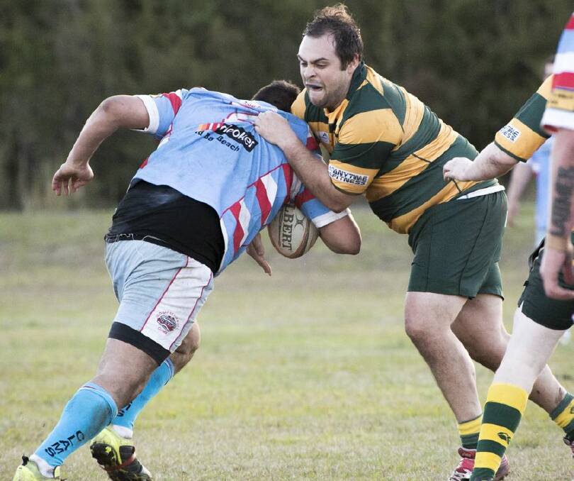 Forster-Tuncurry No 8 forward Chris Simon (right) halts an Old Bar rival in Saturday’s rugby union game at Old Bar. 