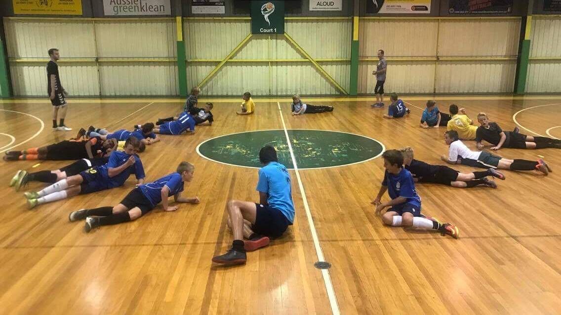 Juniors take part in the Manning Futsal Gol Brazil clinic at Saxby's Stadium at Taree. School coaching clinics will be held at the stadium next week.