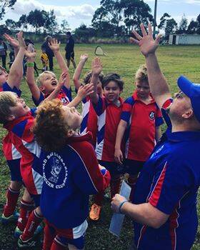 Old Bar under sevens players celebrate after their game.