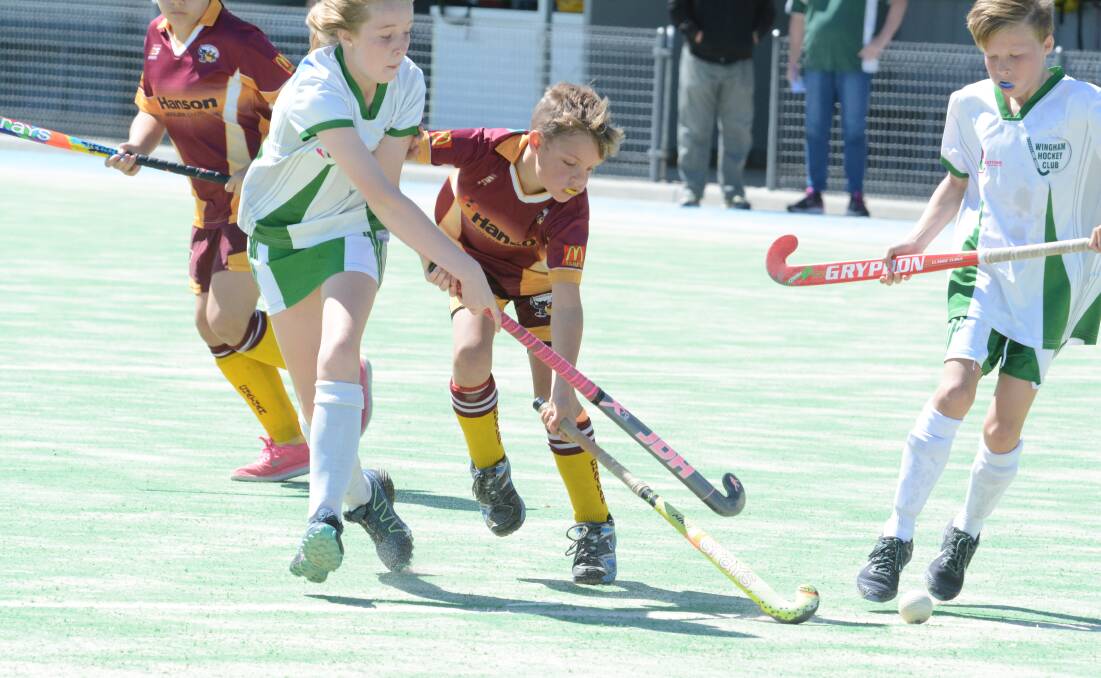 Mia Stone and Leo Allan battle for possession during the Chatham Wolves-Wingham under 11 mixed final. Wingham won the game to advance to Saturday's grand final.