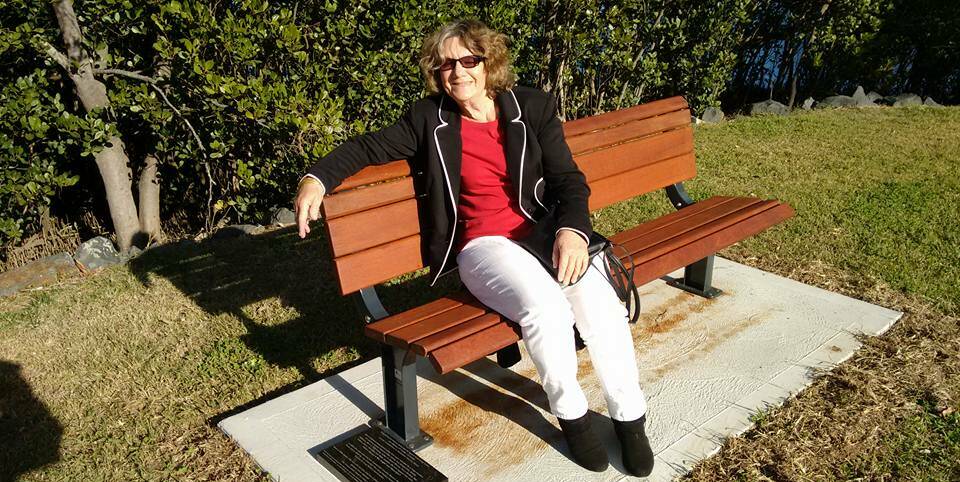 A songwriters' seat: Renowned songwriter and performer Jim Wesley's daughter Sue Noonan on the new Memorial Park seat named in his honour.