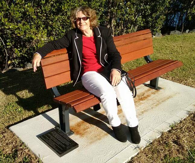 A songwriters' seat: Renowned songwriter and performer Jim Wesley's daughter Sue Noonan on the new Memorial Park seat named in his honour.