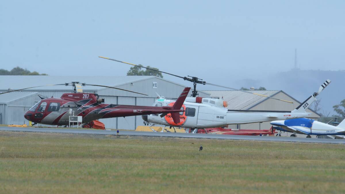 Helicopters are a regular sight over Taree as they carry water to fight fires to the west. They refuel at Taree Airport.