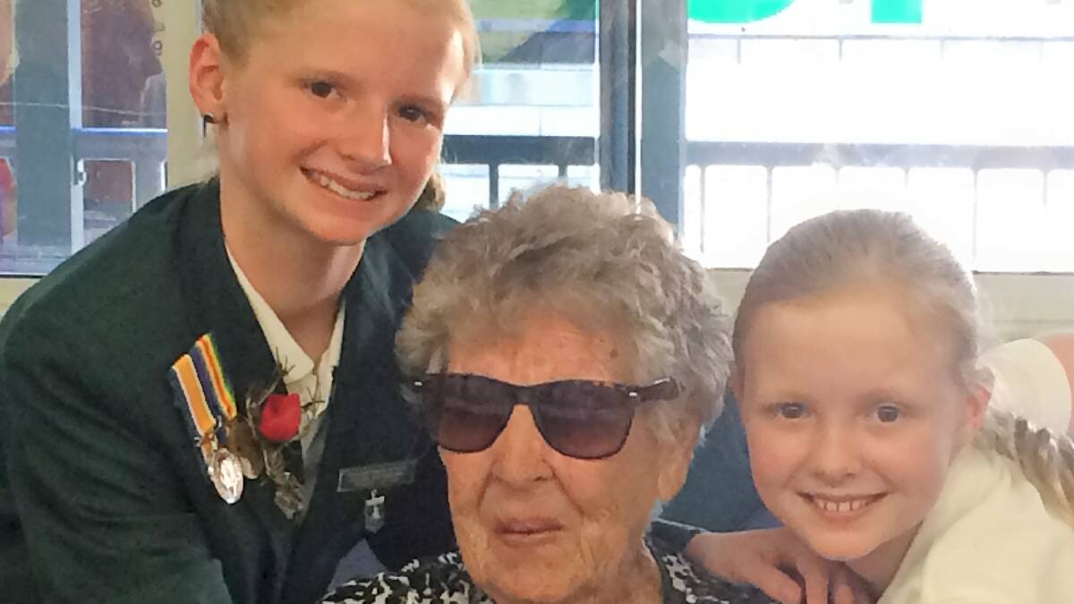 Sub-branch member, Doreen Prebble OAM is welcomed to morning tea by her great granddaughters Allee and Paige Sylvester.
