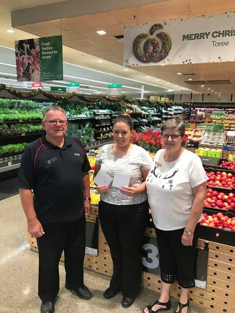 Salvation Army volunteers Keith and Christine Atkinson with assistant store manager at Woolworths Taree Amie Walker (centre).
