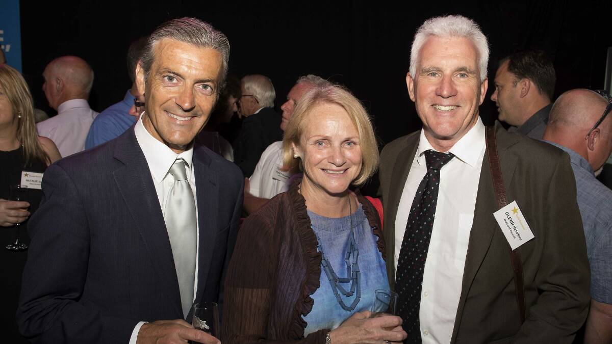 George Ellis with Mary Anne and Glenn Handford at the combined Rotary Clubs of the Manning Valley Christmas cocktail party held on the stage of the Manning Entertainment Centre.