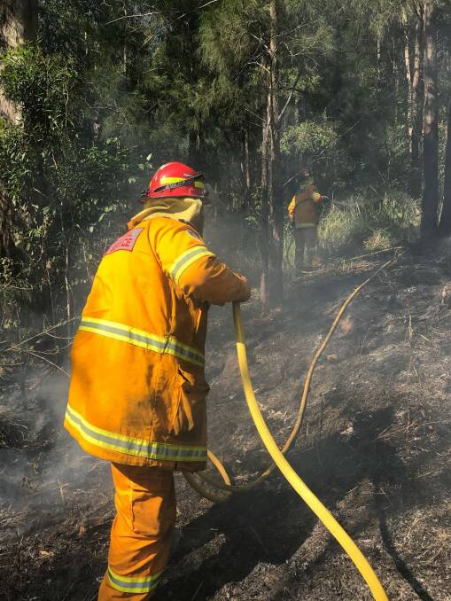 Lansdowne captain and senior deputy captain working away at the back burning operation to stop the spread of the western finger of the fire.