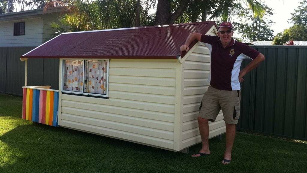 Taree Lions Club member Geoff Thompson proudly delivers the cubby house to Lansdowne.
