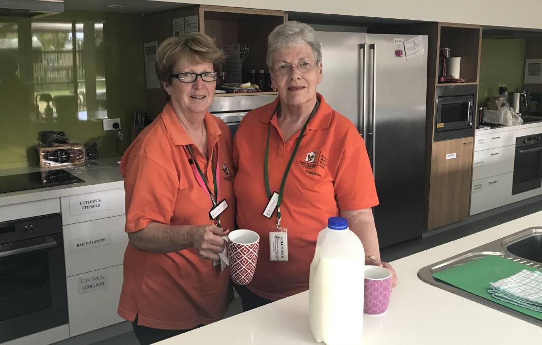 HELPING HANDS: Ronald McDonald House voluteers Mary-Jo Weston and Denise Schmitch on duty at the facility on Thursday. Photo: Supplied