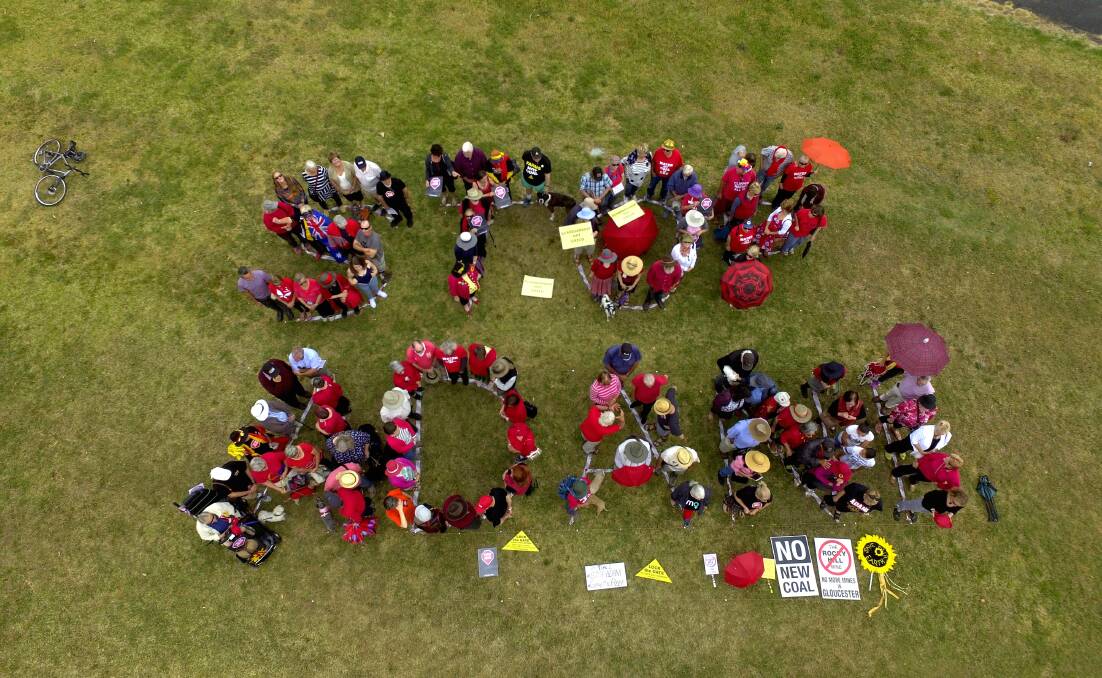 Around 100 people from Gloucester, Forster and Taree gathered at Billabong Park, Gloucester to create the sign. Photo supplied