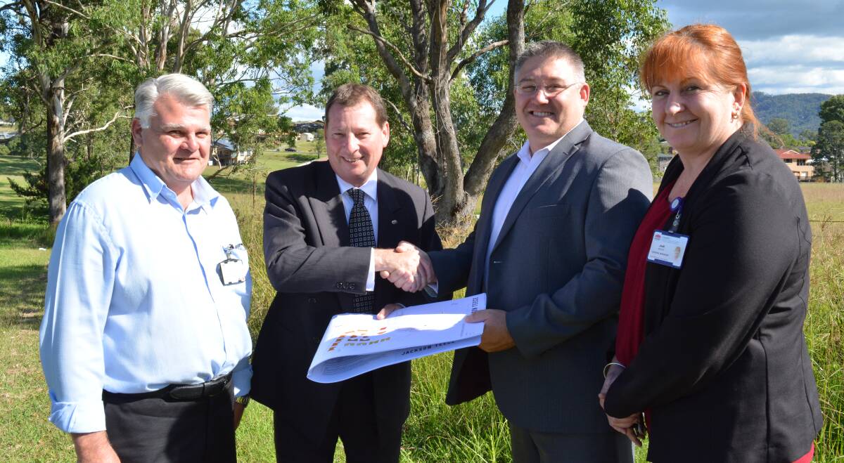 The deal is done: Gloucester Memorial Hospital health service manager, Paul Townsend, Colin Osborne, Paul De Szell and Jodi Nieass at the block in Clement Street. Picture: Anne Keen