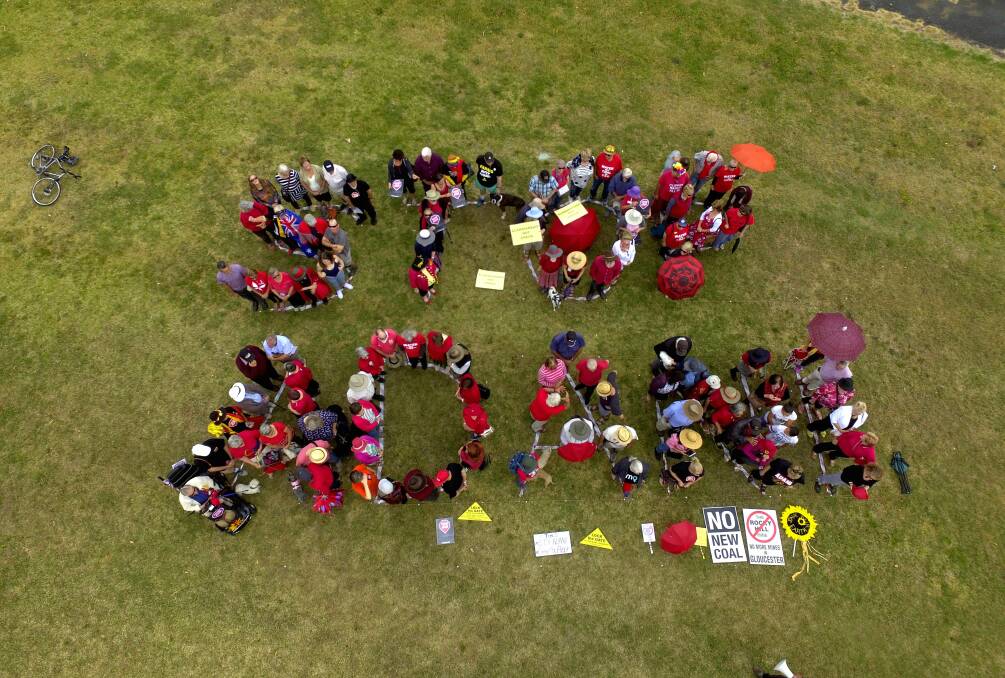 Around one hundred people from Gloucester, Forster and Taree gathered at Billabong Park, Gloucester to create the sign. Photo. Supplied