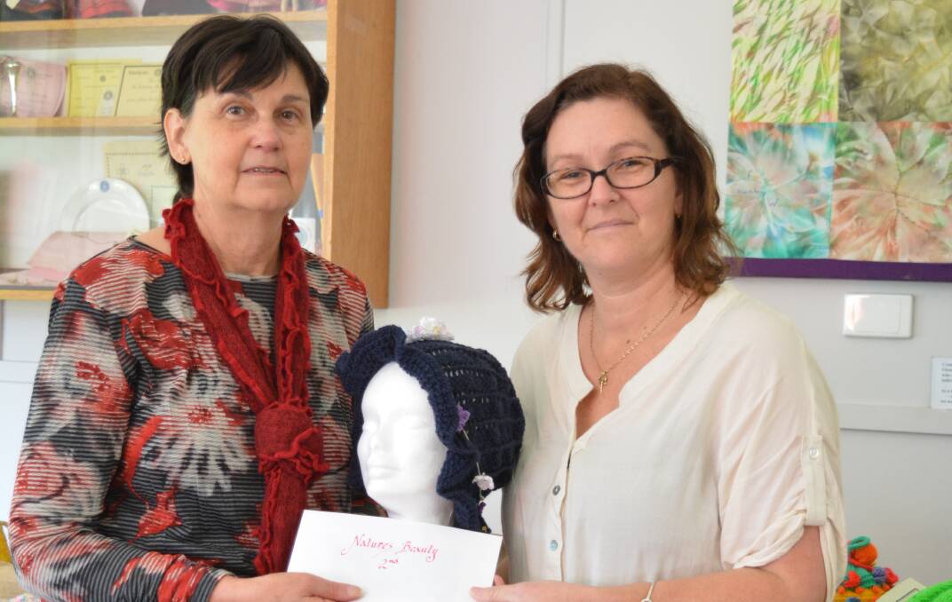 Prize: Mandy Latimore gives Megan Cooley her headwarmer category prize which she donated back to the Breast and Prostate Cancer groups.