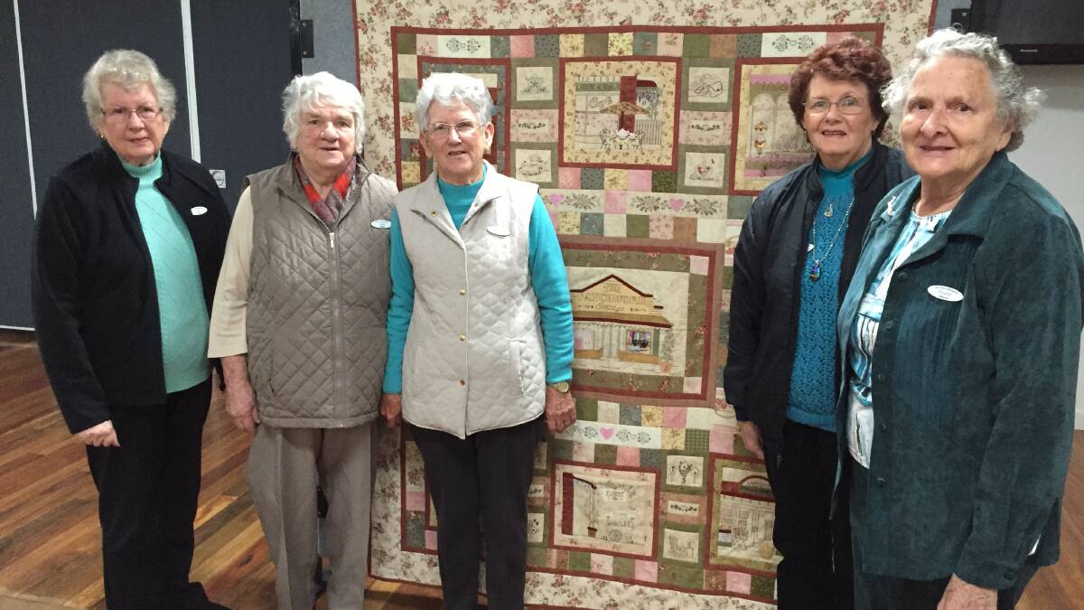  Club Taree Embroidery Group members with the quilt 'Girl's Day Out' which will be the prize in their upcoming exhibition's raffle. 