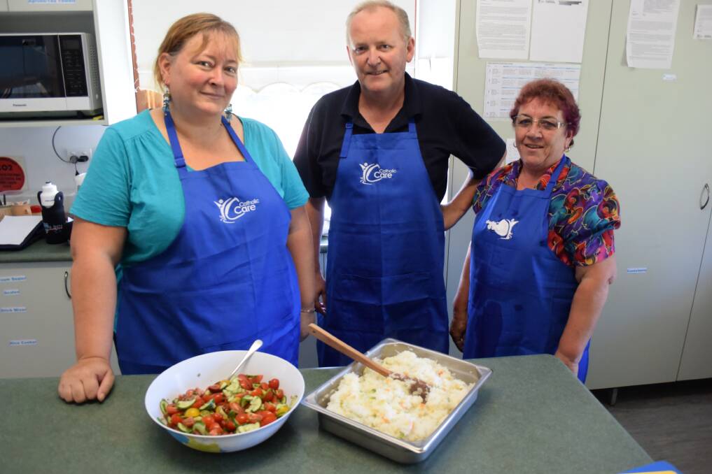 Serving the community: Ruth Sumpner, Walter Tiskins and Bev Wiley volunteer at the Taree Community Kitchen. 
