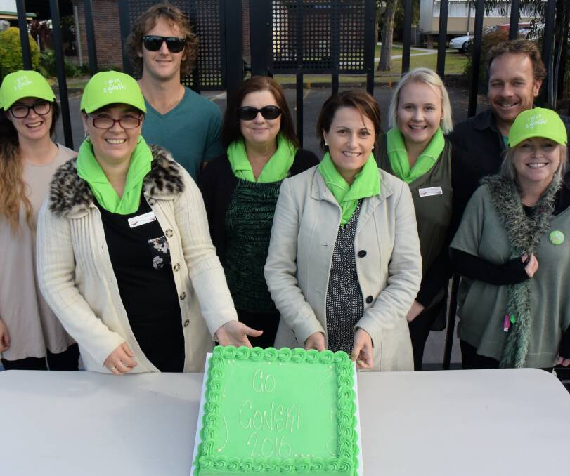 Federation union representative Jacob Cook (back left) and Taree West Public School teachers dressed in green and cut a green 'Go Gonski' cake on Wednesday June 22. 