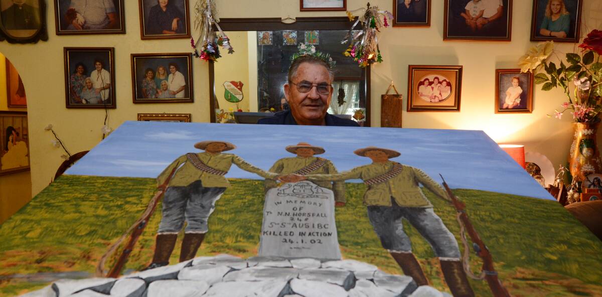 Emotive work: Ray Hurst painted the grave of a soldier who was killed in January 1901, with his comrades standing by.  Photo: Carl Muxlow. 
