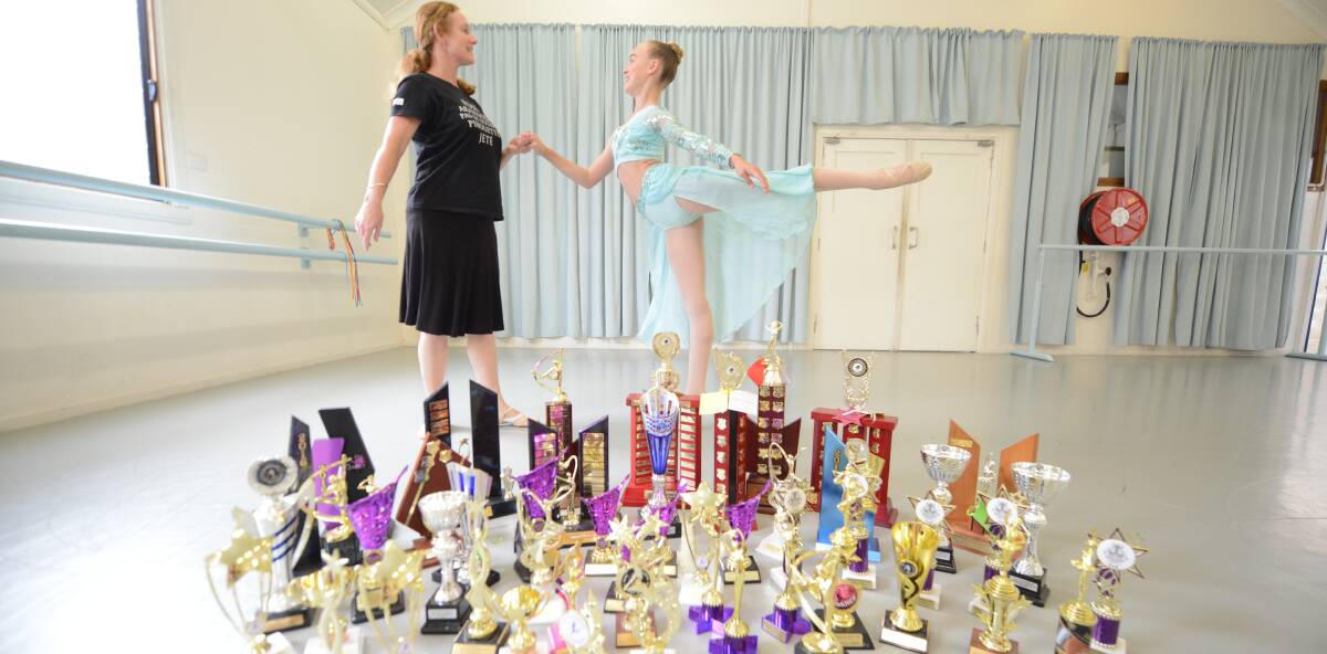 A love for dance: Dance academy director Andrea Rowsell and Zoe O'Bryan with her collection of trophies from 2016. Photo: Scott Calvin. 