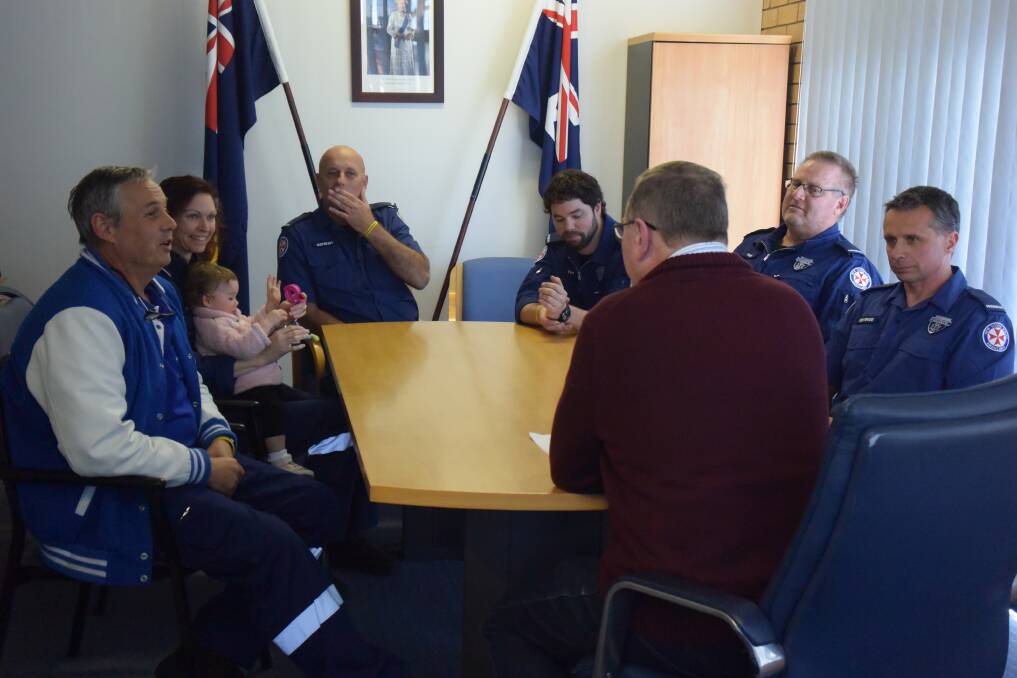 Paramedics talk to member for Myall Lakes Stephen Bromhead. 