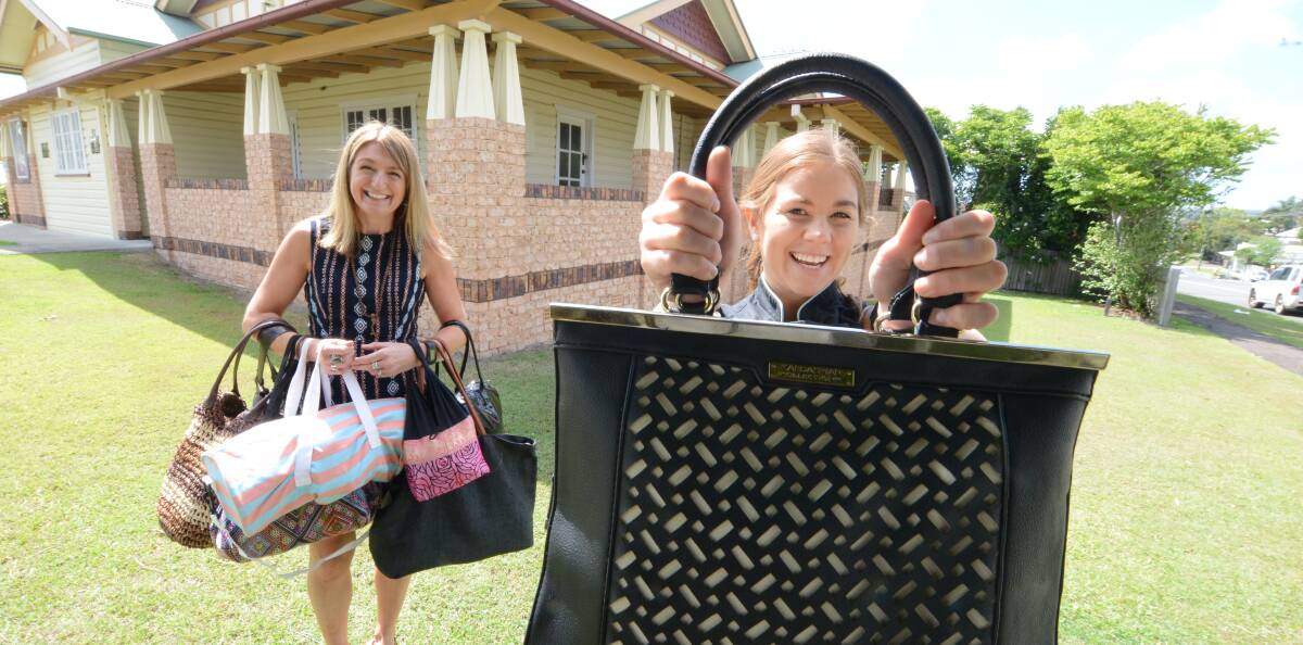 Time to give: Paula Hagan and Candice Balaam outside Taree's Braithwaite Family Dental holding some of the donated bags and goods. 