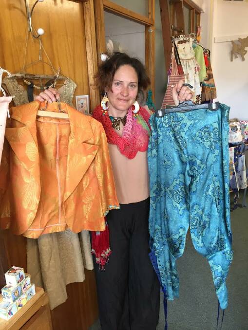 Samantha Everett holds two pieces of clothing she made from old mattress material. 