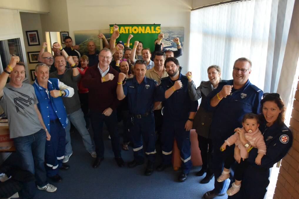Paramedics raise their 'don't hesitate' wrist bands at member for Myall Lakes Stephen Bromhead's Tuncurry office. 