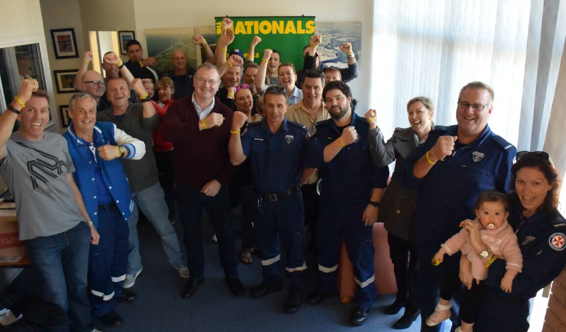 Fair go: Paramedics raise their 'Don't Hesitate' wrist bands at member for Myall Lakes Stephen Bromhead's Tuncurry office. 