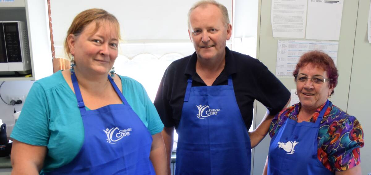 Serving the community: Ruth Sumpner, Walter Tiskins and Bev Wiley volunteer at the Taree Community Kitchen. Ruth spoke at the official opening of the re-vamped kitchen. 