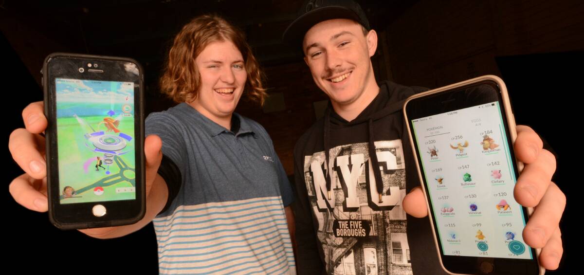 Gotta catch 'em all: Teenagers Lachlan James (Wingham) and Nik Mylonas (Taree) are two of the many people playing the Pokemon Go app in the Manning. Photo: Scott Calvin