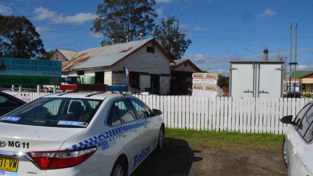 Charged: Police at the Dyers Crossing business, where it will be alleged that a man tried to fire a firearm at another man.