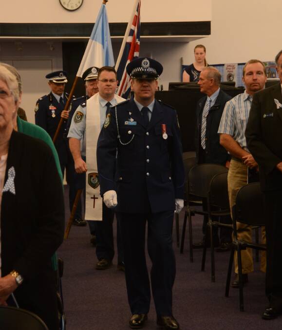 Day of remembrance: Senior Constable Mark Mills leads the procession into the Baptist Church on National Police Remembrance Day. He is followed by Police Chaplain Pastor Chris Thornhill.