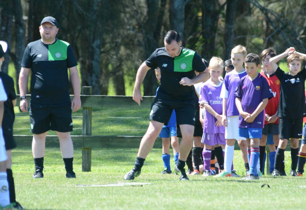 Global game: Celtic coaches Craig Chalmers and Martin Docherty run drills during the coaching clinics held by Celtic FC at Taree. 