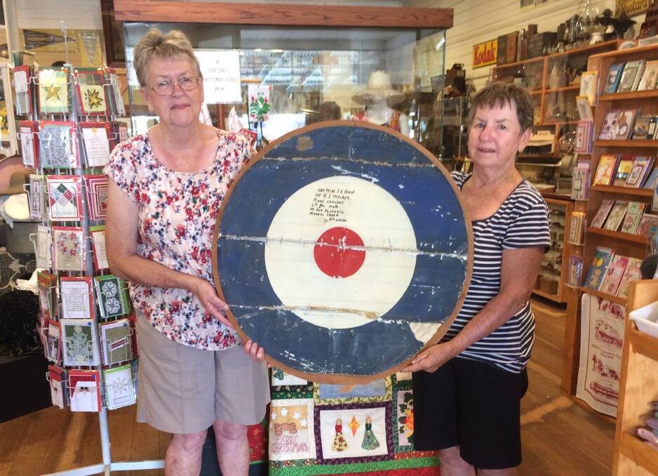 War souvenir: Evelyn Priestly and Colleen Bailey of Gunnedah with the Royal Australian Air Force roundel they donated to Wingham Museum. Photo: Submitted