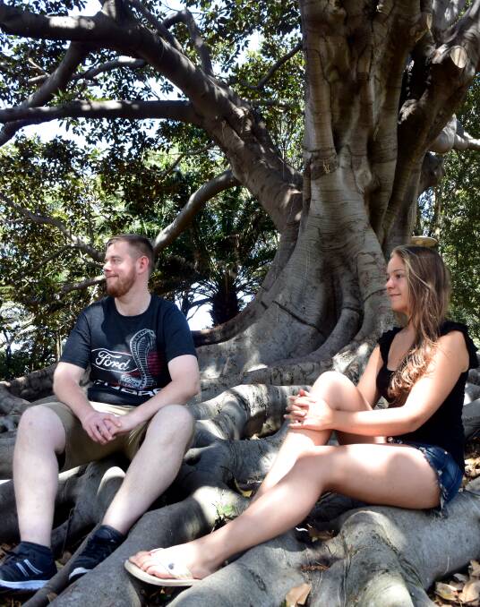LOVING NEWCASTLE: Backpackers Tom Conway, of Ireland, and Pia Moellendorf, of Germany, kicking back in Pacific Park on Thursday. Picture: Brodie Owen