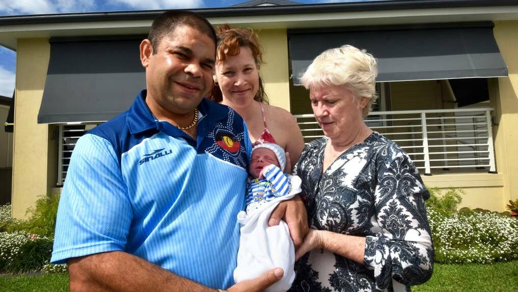 Surprise delivery: Father Doug Toomey holds Elijah James Toomey-Lowry with mother Sarah Lowry (behind) and grandmother Janice Lowry. Elijah was born at Newport Village in Port Macquarie on March 20 at 12.55am.