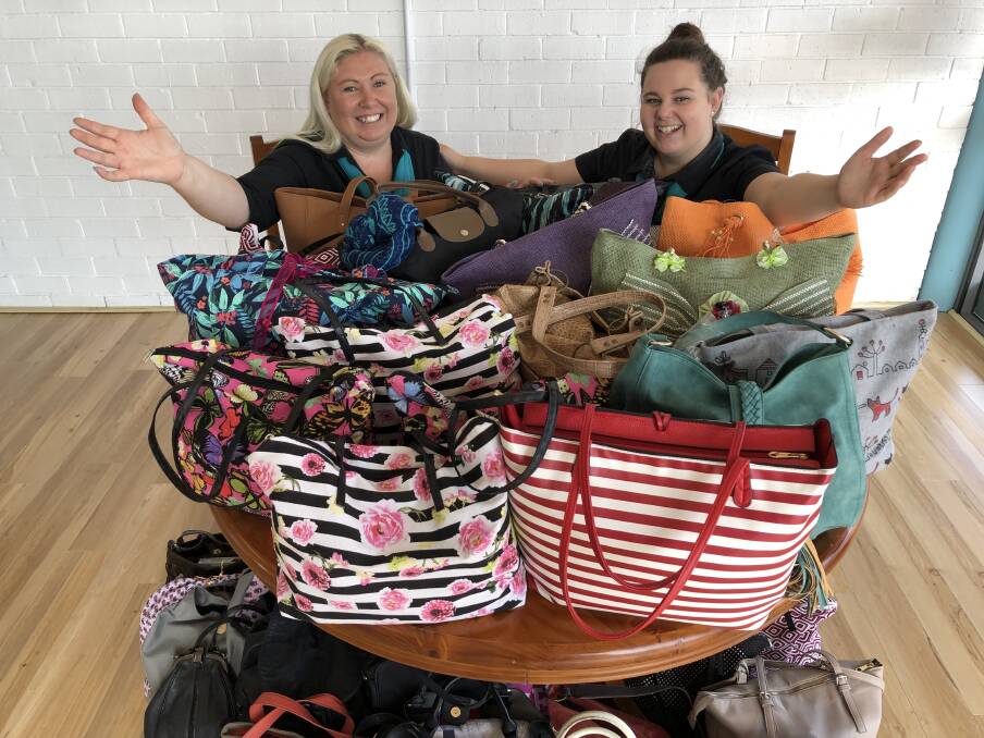 'Share the Dignity Shero' Nicole Wiffen and Samantha Selby with some of the handbags donated during the 'It's In The Bag' campaign. Photo: Ainslee Dennis.