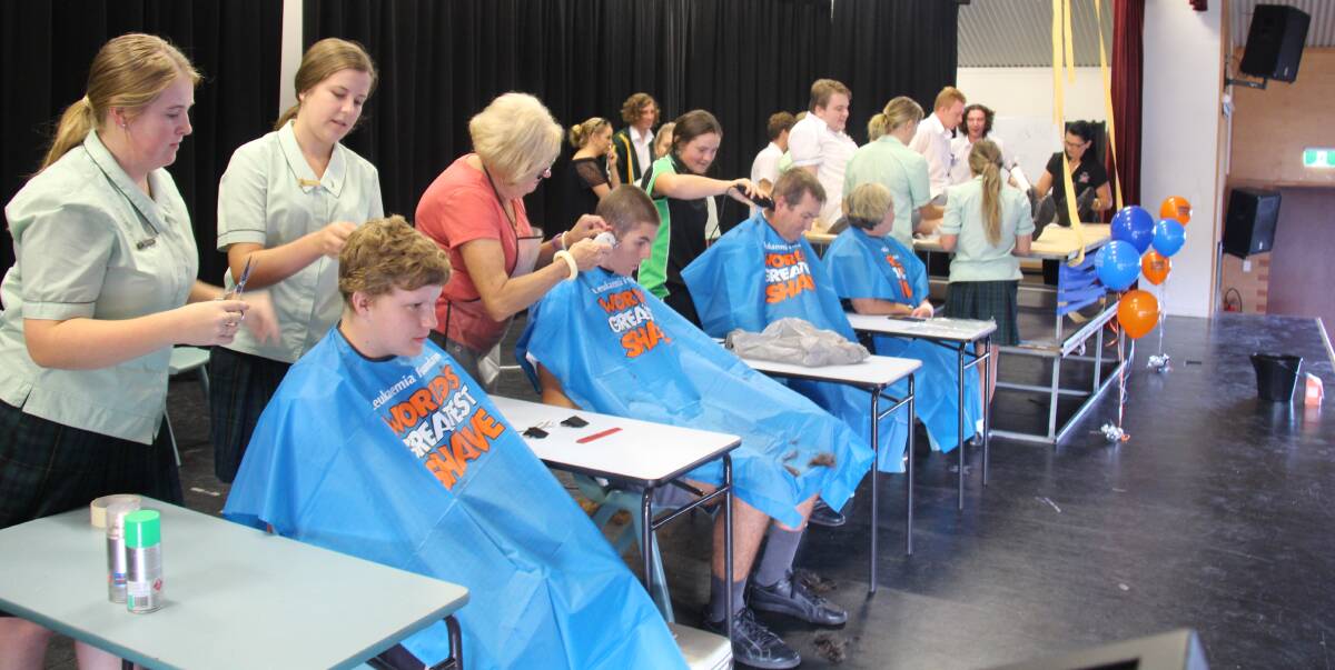 St Clare's High School hosted its World's Greatest Shave event on March 14 in the school hall. From left is Lachlan Shannon-Brown, Odin Augey, teachers Phil Gibney and Mrs Grant, and Joel Dark, Samuel Richardson and Macabe Grass sat on the tables to have their legs waxed.
