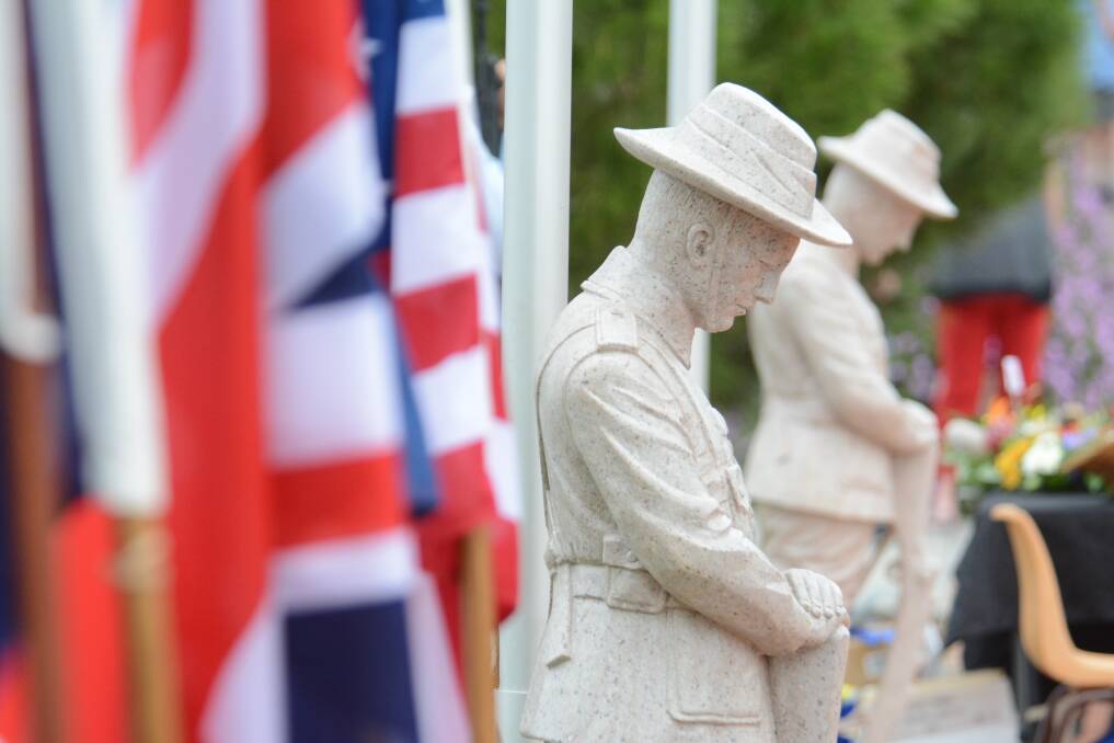 The Digger statues created by Toowoomba stonemasons J H Wager and Sons featured in the Anzac dawn and commemoration services at Taree Memorial Clock. 