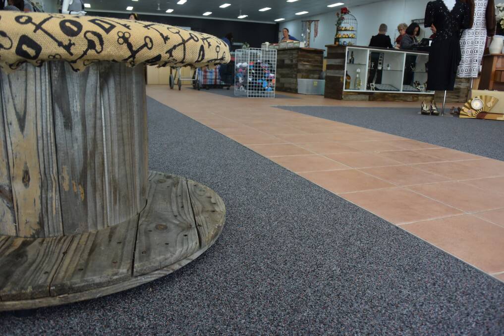 Industrial wooden cable reels have been transformed into seating for customers to use in the shoe section.
