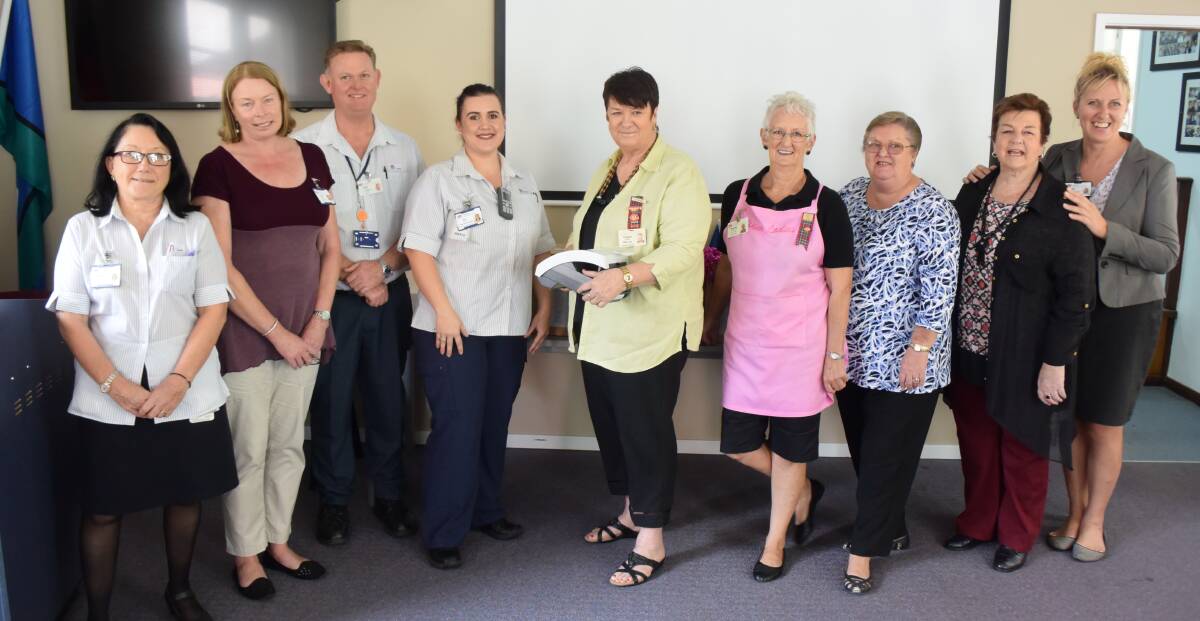 April 2017: Judith Modderno, Leanne O'Grady, Colin Keen, Erin Hunt, Pink Ladies' president Corinne Lang, Beverly Danilczak, Betty Grant, Denise Jones and Sue Arber at the presentation of seven analyser machines for use at Manning and Wingham Hospital. See above story link for more information.