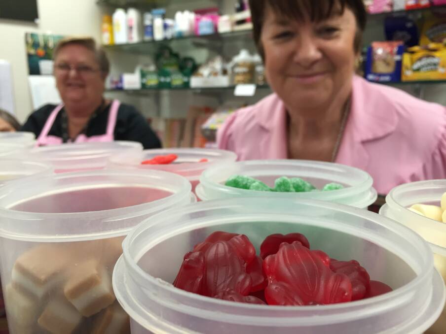 Pink Ladies president Corinne Lang (right) says red frogs are consistently the favourite lolly of Manning Hospital kiosk customers. Photo: Ainslee Dennis.