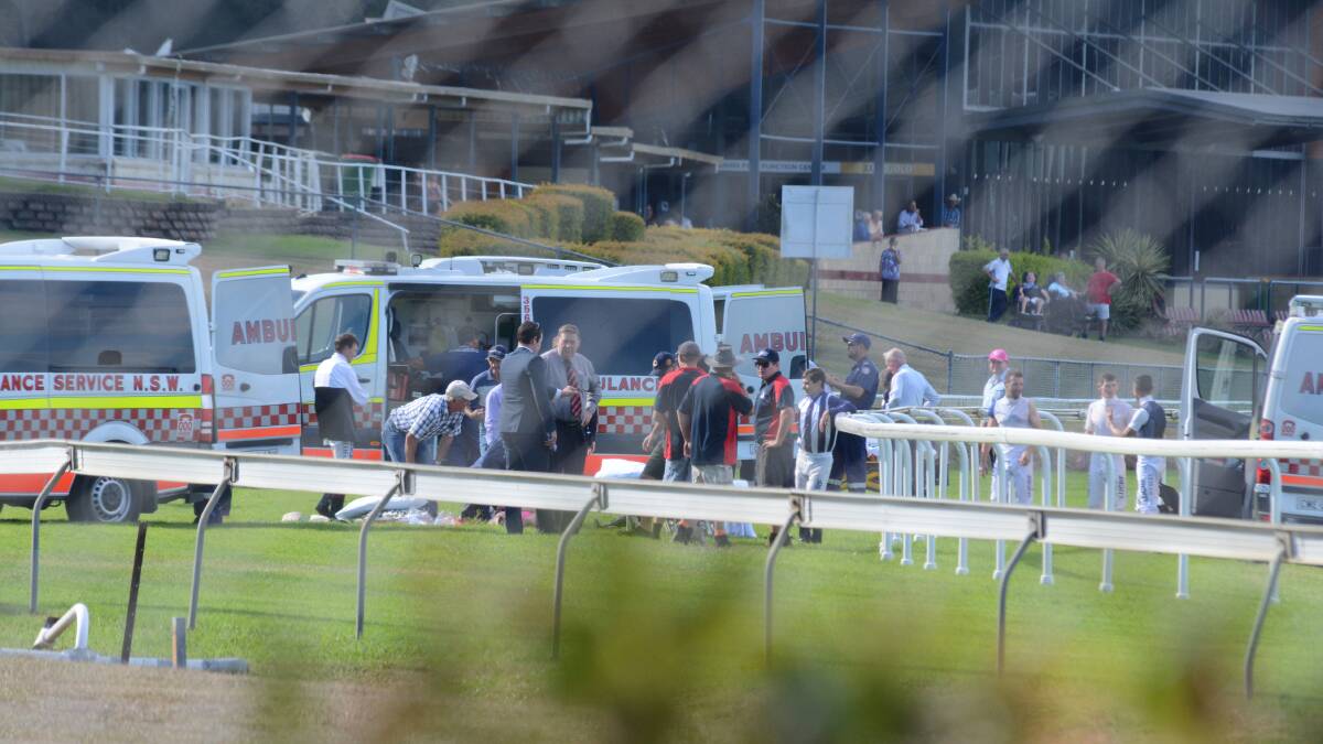 May 23: Ambulance services treat jockeys on-track after the five-horse fall at Bushland Drive Racecourse in Taree.