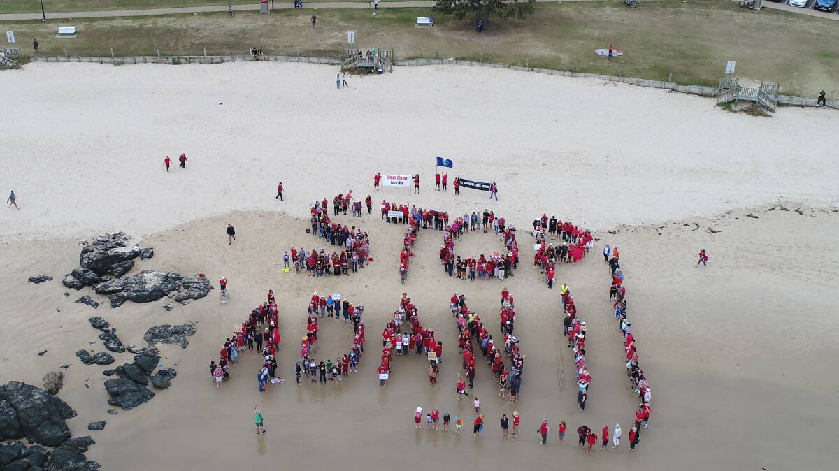 STOP ADANI: An estimated 500 people converged on Town Beach on Saturday afternoon to form the biggest human sign in Port Macquarie’s history.