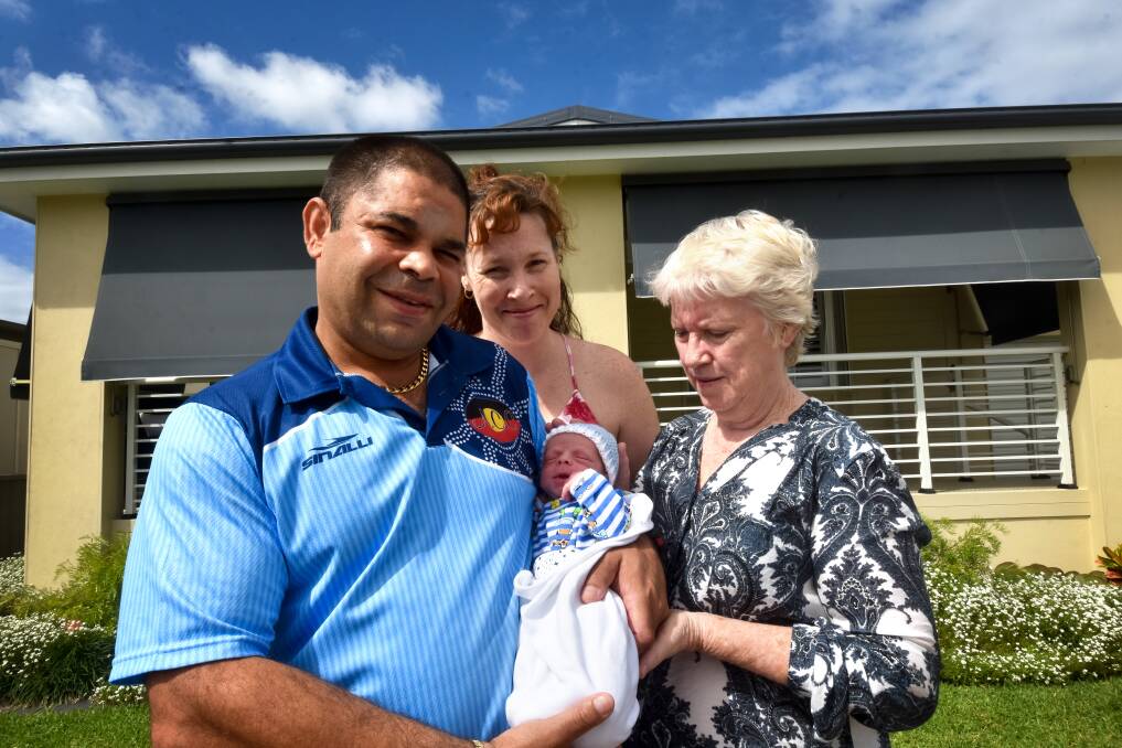 Surprise delivery: Father Doug Toomey holds Elijah James Toomey-Lowry with mother Sarah Lowry (behind) and grandmother Janice Lowry. Elijah was born at Newport Village in Port Macquarie on March 20 at 12.55am.