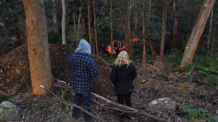 The parents of Matthew Leveson, Mark Leveson (left) and Faye Leveson (right) at the site where the search continues for the burial place of their son Matthew Leveson in the Royal National Park at Waterfall, NSW. 31st May, 2017. Photo: Kate Geraghty
