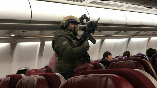 Security personnel board flight MH128 after it returned to Melbourne. Photo: Andrew Leoncelli

