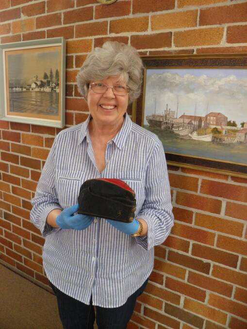 Storytelling: Port Macquarie Museum volunteer Margaret Blight with the Boer War Forage Cap recently documented for the Stitches, Threads & Yarns project. 